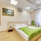 Кровать в номере Полулюкс в отеле Минима Кузьминки