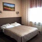 Кровать в номере Стандарт Премиум+ в отеле Зима