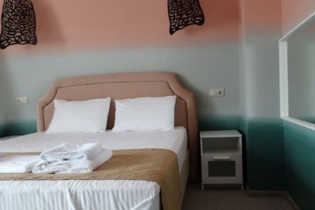 Кровать в номере Полулюкс Афина в отеле Элитон