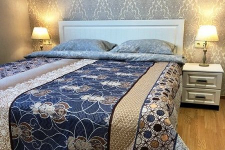 Спальная зона в номере Делюкс в отеле Flori Hotel