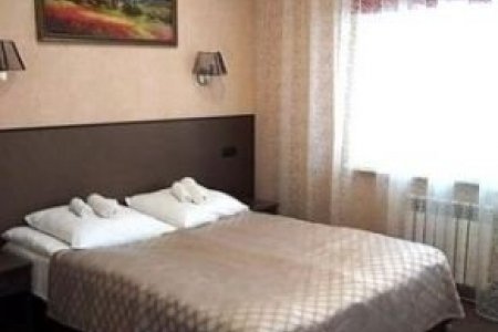 Кровать в номере Стандарт Премиум+ в отеле Зима
