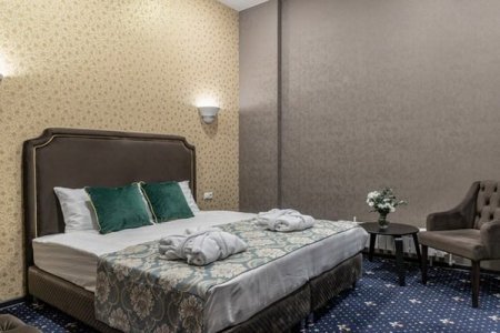 Кровать в номере Делюкс в отеле Моцарт