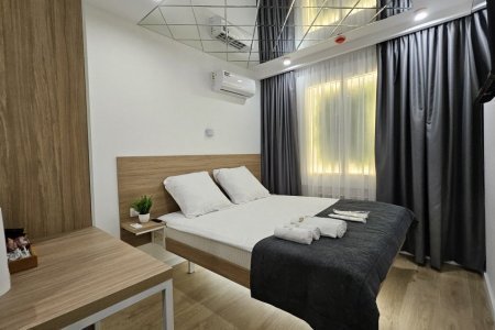 Кровать в номере Стандарт 6 в отеле Buta Hotel 2