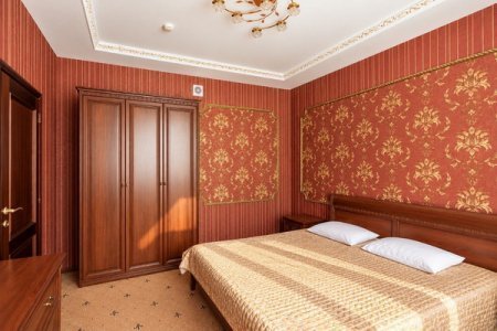 Кровать в номере Двухкомнатный Люкс в отеле Автор Люблино