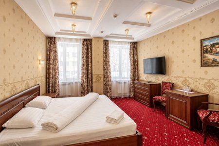 Спальная зона в номере Комфорт в отеле Автор