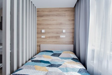 Кровать в студии 4 в апартаментах Home Like