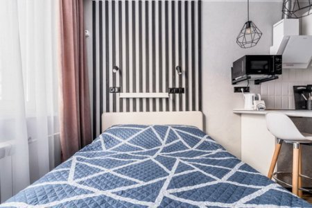 Кровать в студии №19 в апартаментах Home Like