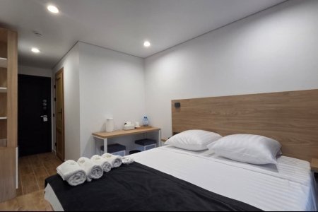 Кровать в номере Комфорт №2 в отеле Buta Hotel 4