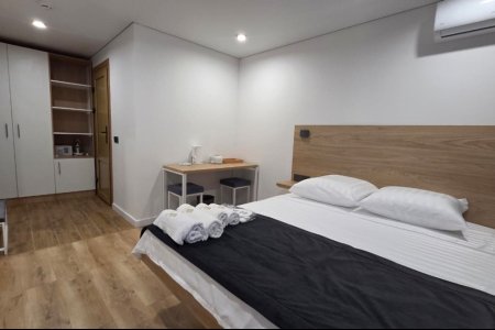 Кровать в номере Комфорт №3 в отеле Buta Hotel 4