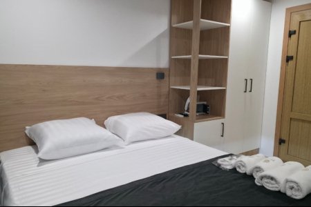 Кровать в номере Комфорт №4 в отеле Buta Hotel 4
