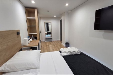 Кровать в номере Комфорт №7 в отеле Buta Hotel 4