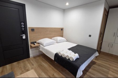 Кровать в номере Стандарт №8 в гостинице Buta Hotel 4